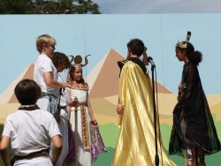 Children performing outdoor theater in an Egyptian motif