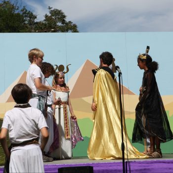 Children performing outdoor theater in an Egyptian motif